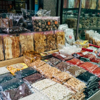 An indoor market stall showcasing a diverse selection of dried foods and spices.