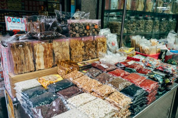 An indoor market stall showcasing a diverse selection of dried foods and spices.