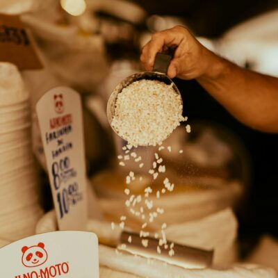 Close-up of hand scooping tapioca at a market. Perfect for food and culture themes.