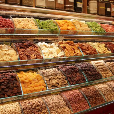 Colorful display of dried fruits and nuts in a market. Perfect for food or lifestyle topics.