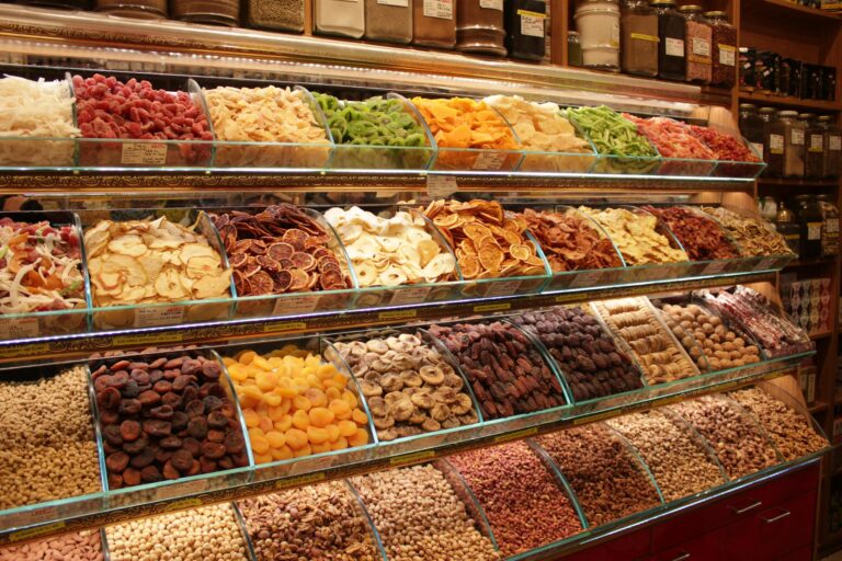 Colorful display of dried fruits and nuts in a market. Perfect for food or lifestyle topics.