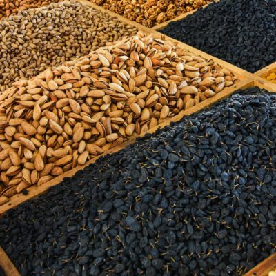 Variety of nuts and seeds displayed at a market. Ideal for culinary and health themes.